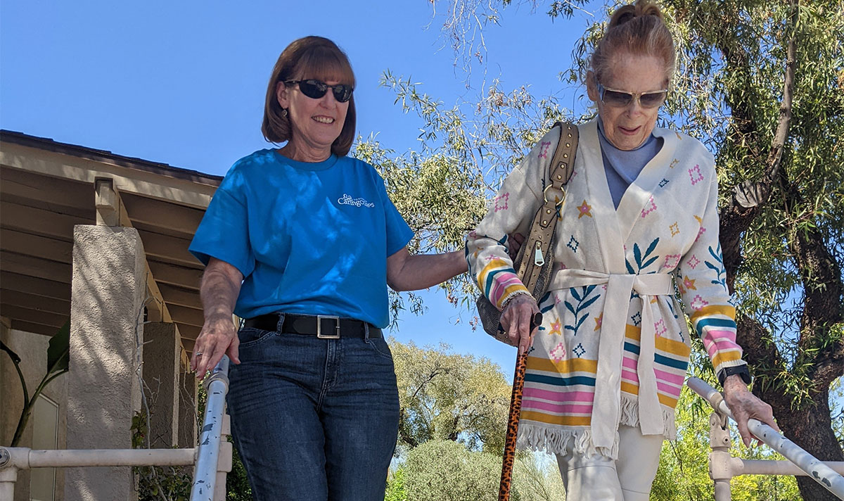 helping elderly down stairs