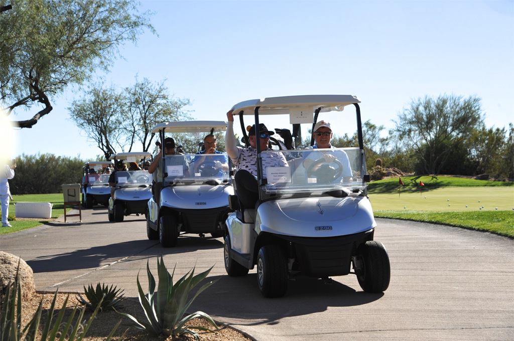 golfers in golf cart having a good time at Foothills Caring Corps Golf Classic Fundraiser